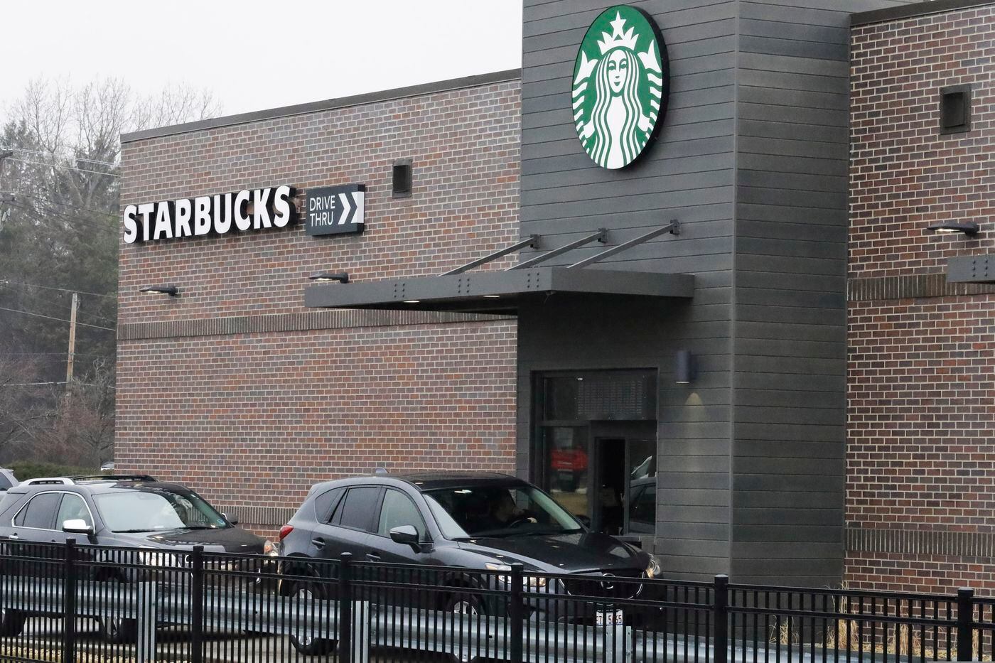 Customers wait for their order in their car at a Starbucks in Northbrook, Ill. earlier this month.