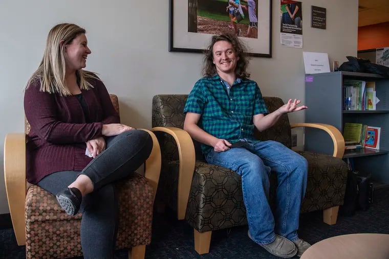 Ryan Moran (right), a senior who gets services at the Kinney Center, interacts with Alli Gatta, associate  director of college autism support at St. Joseph's University Thursday.  A new residence hall will open at St. Joe's in the fall. The university is home to the Kinney Center for Autism Education and Support.