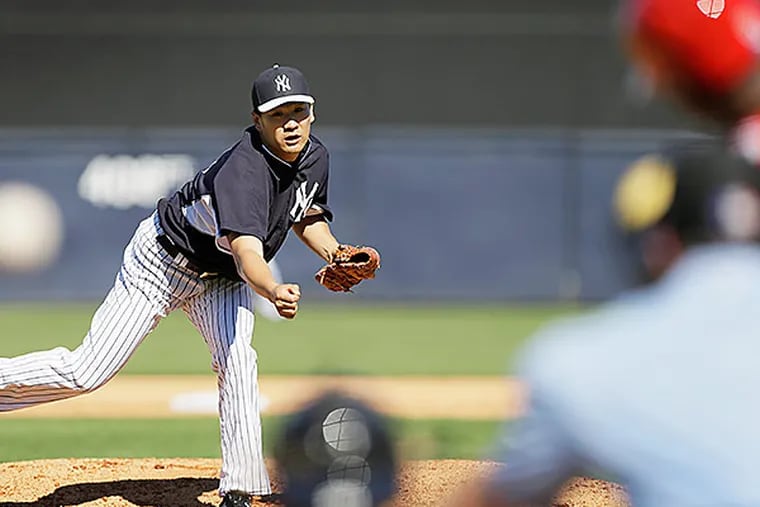New York Yankees pitcher Masahiro Tanaka throws a pitch during the sixth inning against the Philadelphia Phillies. (AP Photo/Charlie Neibergall)