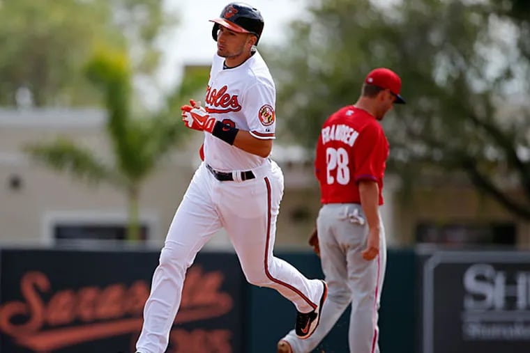 The Orioles' Ryan Flaherty (3) rounds second past Philadelphia Phillies second baseman Kevin Frandsen (28) after hitting a two-run home run off Phillies starting pitcher A.J. Burnett in the second inning of an exhibition spring training baseball game in Sarasota, Fla., Friday, March 7, 2014. The Orioles won 15-4. (Gene J. Puskar/AP)