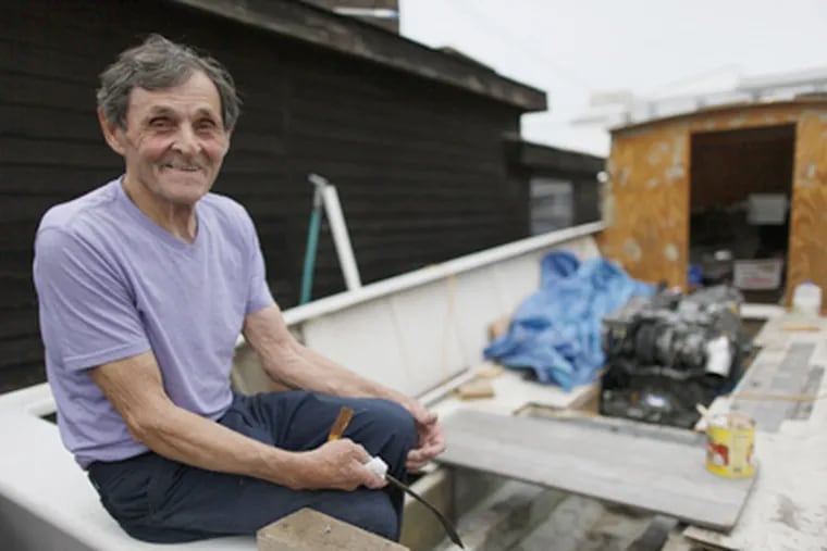 Carmen Conti, 82, aboard the boat he is building in his yard. (Michael S. Wirtz / Staff Photographer)