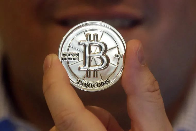 FILE -Bitcoin doesn’t exist in the physical world. If it did, bitcoin might look like this mockup. (AP Photo/Rick Bowmer, File)