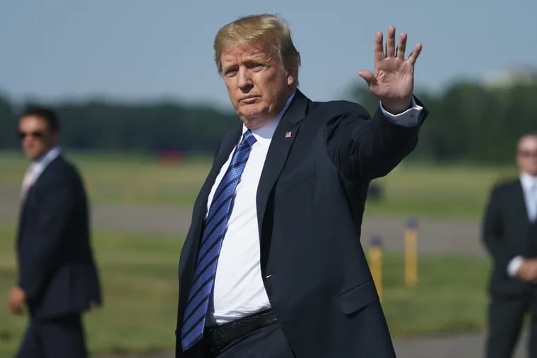 President Trump waves as he arrives on Air Force One at Morristown Municipal Airport, in Morristown, N.J., en route to Trump National Golf Club in Bedminster, N.J.
