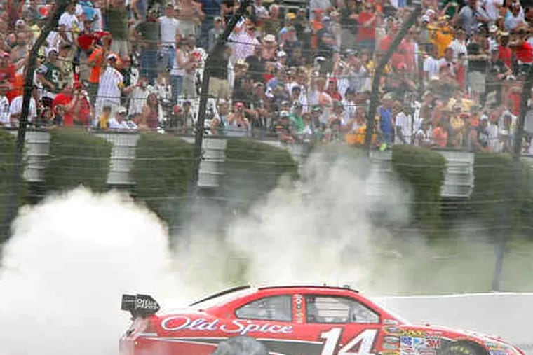 Tony Stewart smokes the tires of his No. 14 Chevrolet to celebrate his Pocono 500 victory.