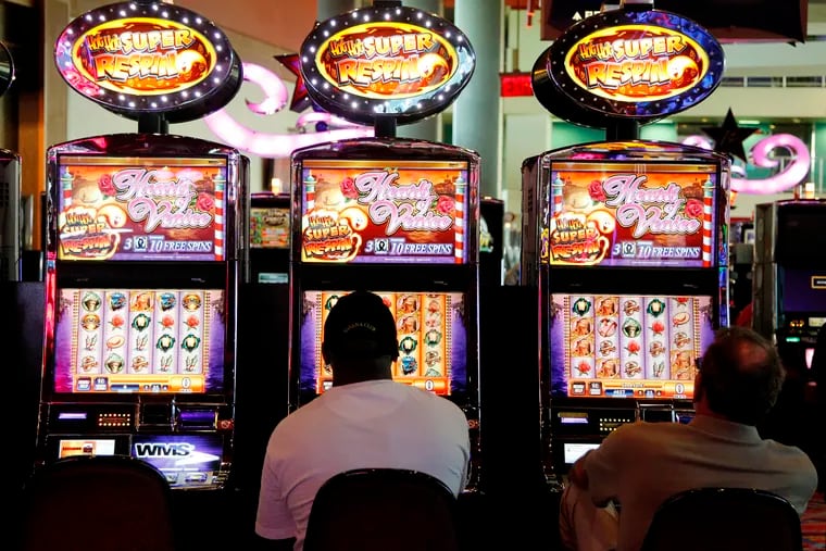 Patrons play the slot machines at Harrah's Philadelphia Casino & Racetrack in Chester, Pa. The casino's parent is being sued for copyright infringement.