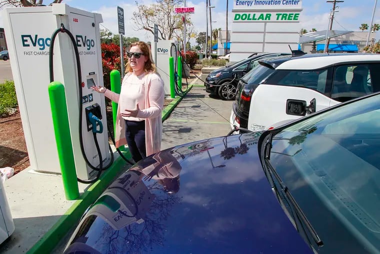 Electric vehicle owner Brianne Van Gorder speaks about her frustrations using charging stations, in San Diego on April 2, 2019. Less than a month ago, Van Gorder and her husband bought their first zero-emissions vehicle, a Volkswagen eGolf.