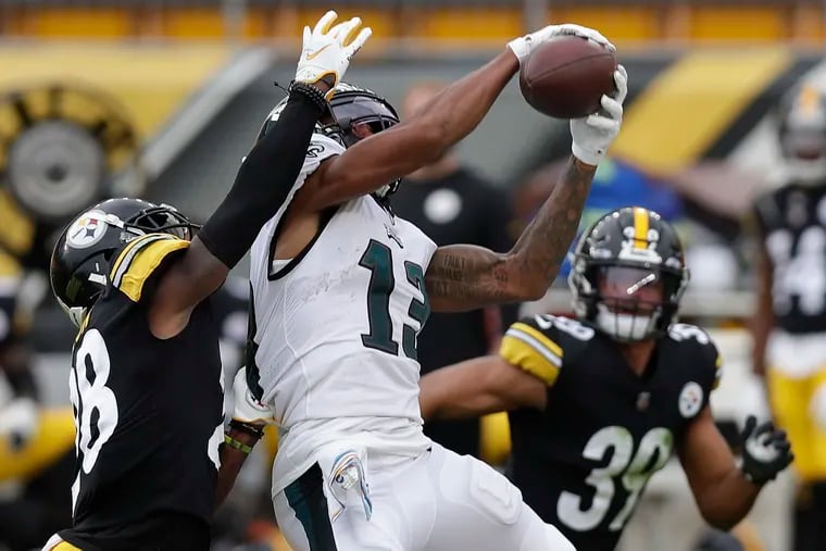 Eagles wide receiver Travis Fulgham catches the football past Pittsburgh Steelers cornerback Mike Hilton (left) and free safety Minkah Fitzpatrick during the third quarter of Sunday's 38-29 loss.