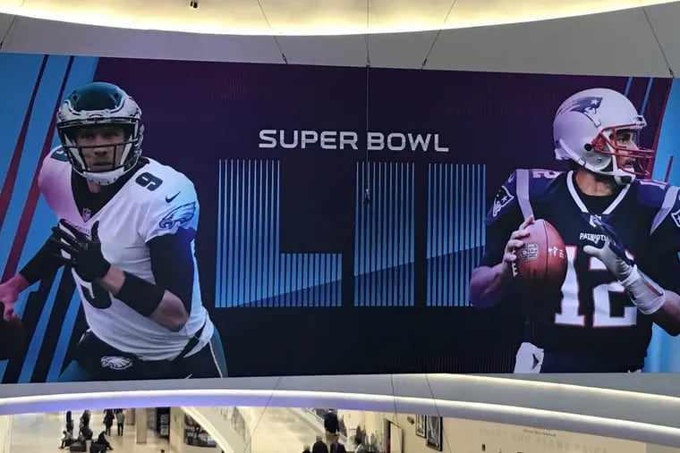 A banner hanging at the Mall of America showing Nick Foles (left) and Tom Brady.