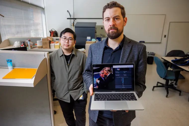 Matthew Stamm (right), director of Drexel University's Multimedia and Information Security Lab, leads a team working on finding false images created by AI. Tai Nguyen (left), a graduate research assistant, stands alongside Stamm as he displays an AI image of former President Donald Trump, which they debunked.