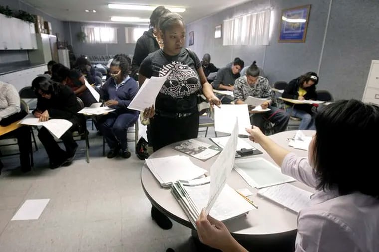 Job seeker LaToya Luke, 25, hands in her evaluation form atthe South Los Angeles WorkSource Center. New claimsfor jobless benefits dropped more than expected last week.