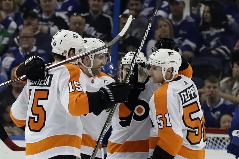 Flyers winger Jori Lehtera (left) celebrating with his teammates after scoring a goal in a recent game in Tampa.