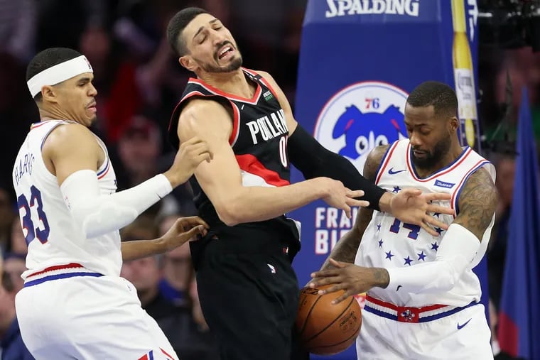 The Sixers'  Jonathon Simmons (14) knocking the ball away from the Trail Blazers' Enes Kanter (00) during a February game.