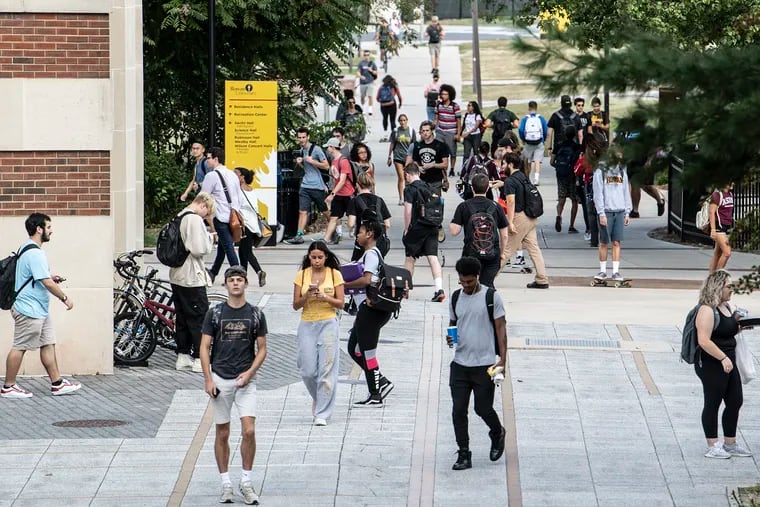 Students walk through campus at Rowan University in Glassboro, N.J.