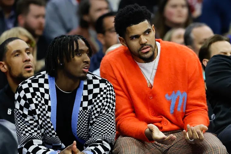 Injured Sixers forward Tobias Harris and guard Tyrese Maxey watch their teammates take on the Golden State Warriors in the first quarter on Friday.