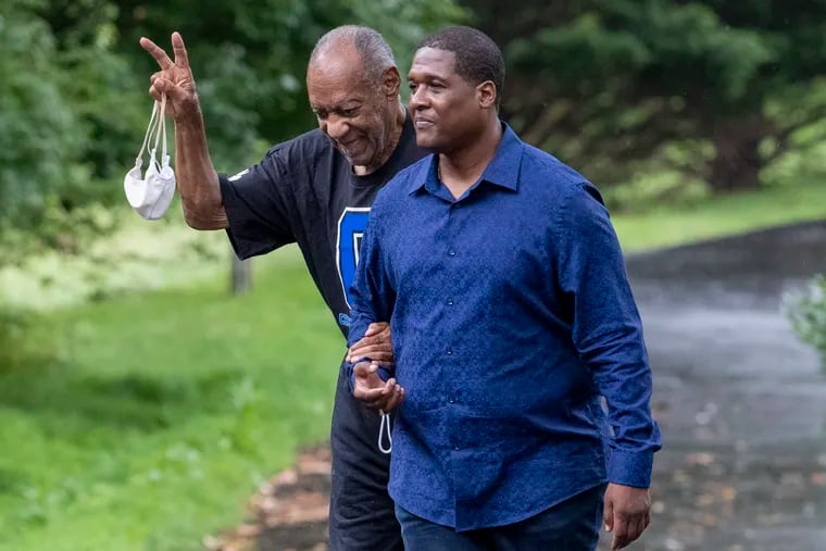 Bill Cosby leaves his home in Elkins Park on Thursday with spokesperson Andrew Wyatt. Cosby was released from prison yesterday after the Pennsylvania Supreme Court overturned his sexual assault conviction.
