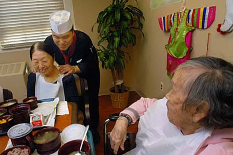 The chef, Jong Soo Kim, at Mount Laurel's Innova Health & Rehab, chats with resident Bok Soon Kim; at right is resident Imki In. (APRIL SAUL / Staff Photographer)