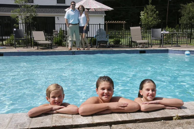 Part of the renovation overseen by homeowners Eric and Sarah Cornwell (rear) included cleaning up the pool, which hadn't been used in 20 years. Enjoying the water (from left) are Finn, 6, Harrison, 12, and Amelia, 10.