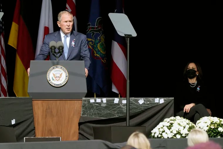 Former President George W. Bush speaks during a memorial for the passengers and crew of United Flight 93 in Shanksville, Pa., as Vice President Kamala Harris (right) looks on.