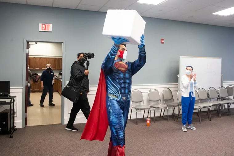 Skippack Pharmacy pharmacist Mayank Amin, known to don superhero costumes during his work, arrives Sunday with vials of COVID-19 vaccine for a vaccination clinic at the Skippack Fire Co.