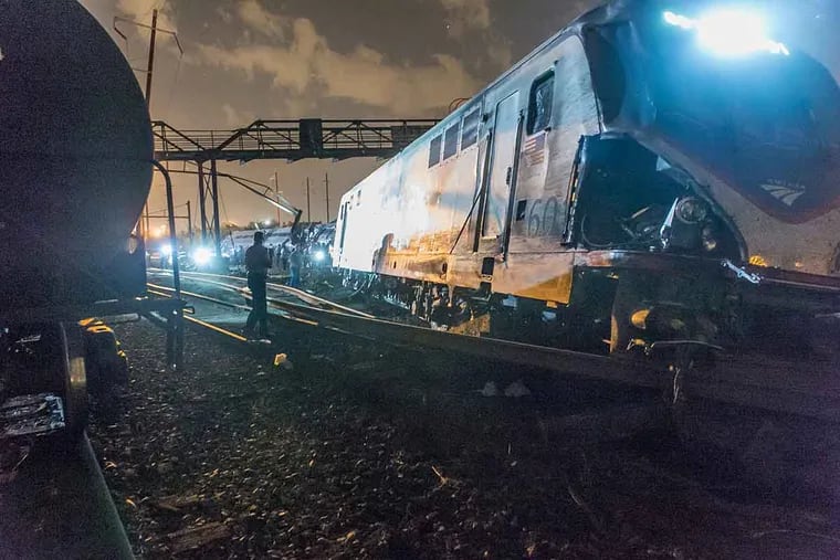 The engine of Amtrak Train 188 lay across several tracks after the train derailed May 12 in Philadelphia.