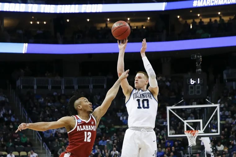 Villanova’s Donte DiVincenzo makes a three-point shot over Dazon Ingram of Alabama in the first half of Saturday’s NCAA second-round win.
