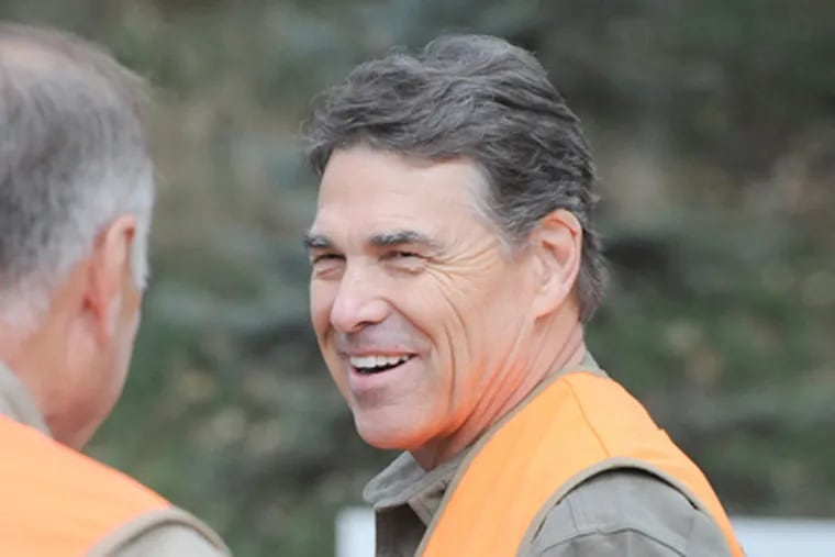 Rick Perry looked at home while hunting pheasant. But, then, he is a hunter, unlike some candidates. (Dave Weaver / Associated Press)