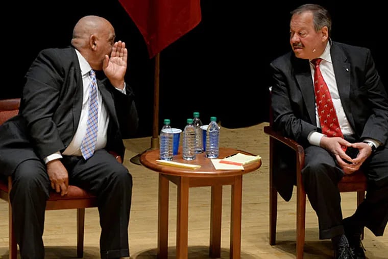 Is Milton Street (left) trying to sell Nelson Diaz some 'sky rocks' at Monday night's mayoral debate at Temple University?