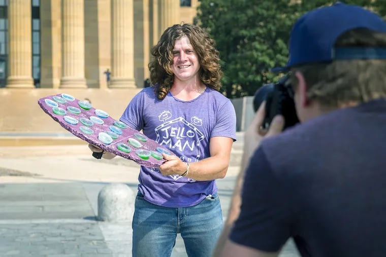 Fillmmaker Colin Kerrigan takes photographs of Paul Vile, also known as Jelloman, at the Philadelphia Museum of Art, for his upcoming documentary "Jelloman, if u will." Vile got his name and notoriety from selling jello shots at music festivals across the country.