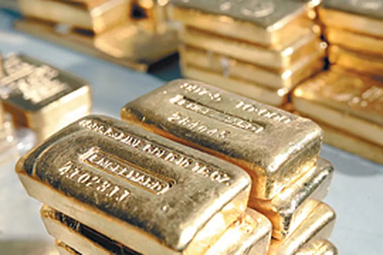 Stacks of gold bars at FideliTrade, near Wilmington. Usually, the bars are not moved - the firm just keeps track of who trades it and where it is. (Michael Perez/Inquirer)