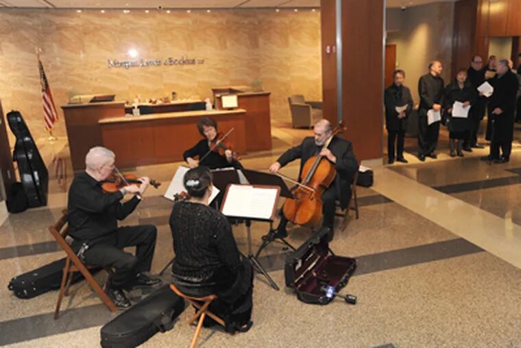 Protesting the Philadelphia Orchestra's filing for bankruptcy last April, musicians played in a law office. (April Saul / Staff Photographer)