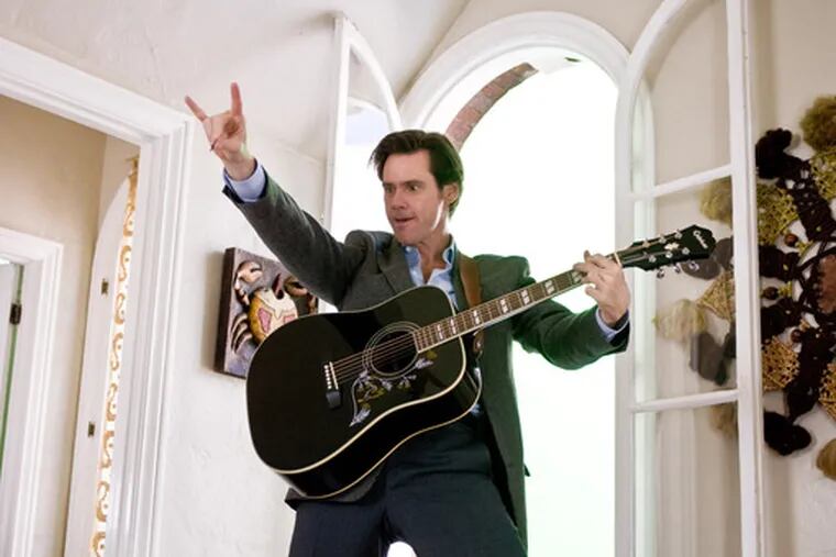 Jim Carrey as &quot;Yes Man&quot; Carl, playing guitar, learning Kor- ean, piloting an airplane, and generally finding joy for once.