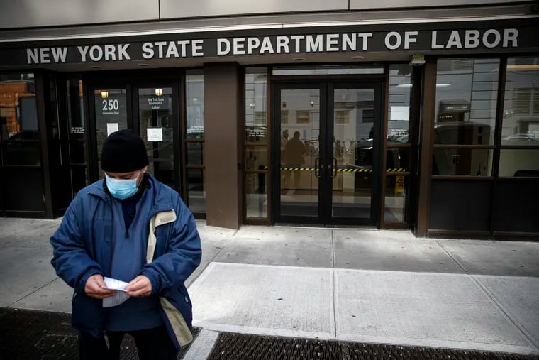 In this March 18 photo, visitors to the Department of Labor were turned away at the door by personnel because of closures over coronavirus concerns in New York.