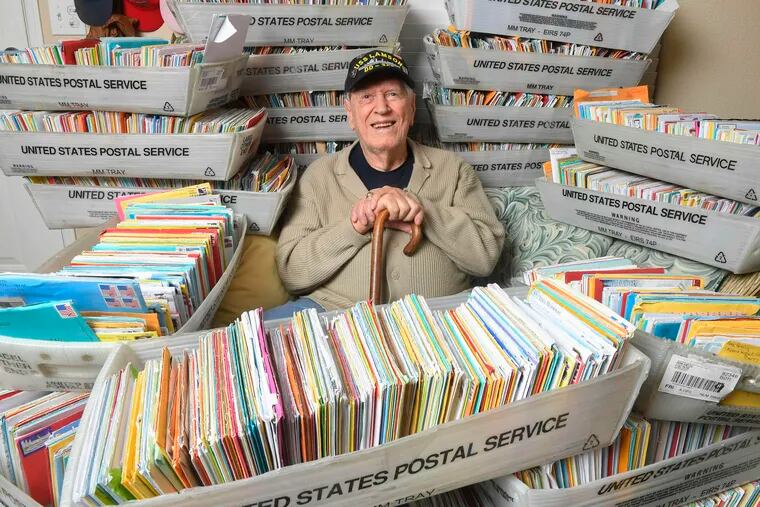 In this Tuesday, Jan. 8, 2019 photo, Duane Sherman, 96, poses at home with a small fraction of the 50,000 birthday cards he's received after his daughter's social media request for people to send him cards to cheer him up on his birthday went viral in Fullerton, Calif.  (Kevin Sullivan/The Orange County Register via AP)