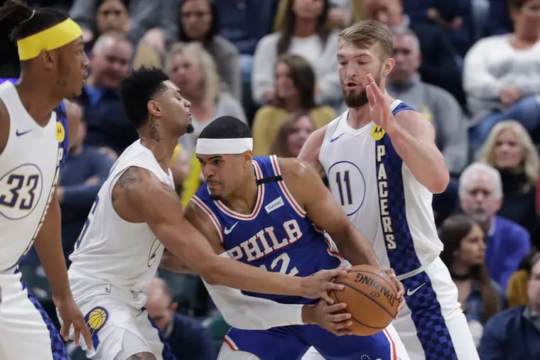 Tobias Harris (12) getting double-teamed by Pacers Jeremy Lamb (26) and Domantas Sabonis (11) during the first half Monday.