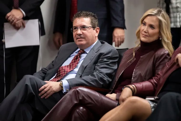 Washington Commanders owner Dan Snyder (left) and his wife, Tanya Snyder, listening to head coach Ron Rivera during a news conference in January 2020,