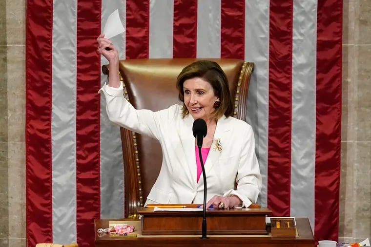 Speaker of the House Nancy Pelosi presides over House passage of President Biden's expansive social and environment bill at the Capitol in Washington on Friday.