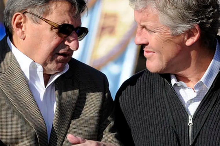 Rival coaches Joe Paterno (left) and Pete Carroll talk after a Rose Bowl news conference at Disneyland yesterday.