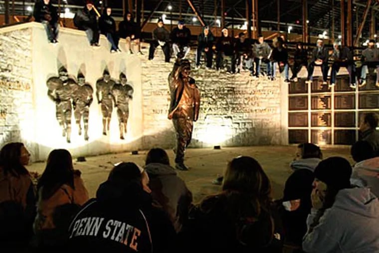 Students gather around the Joe Paterno statue outside of Beaver Stadium on Wednesday night. (David Swanson/Staff Photographer)