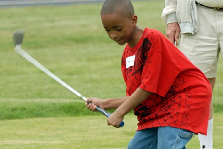 Kendel Conte-Sauners  takes a swing during the Mid-Atlantic Junior Blind Golf Association’s tournament at the Overbrook School for the Blind. (Ron Tarver / Staff Photographer)