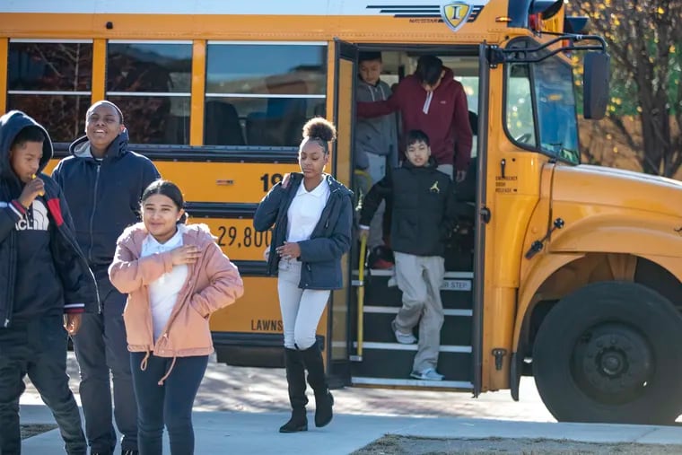 Students from Octavius V. Catto Community School get off the bus to visit Mastery Prep High School as part of a tour of Camden's seven district and charter high schools in December 2019.