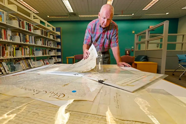Jim Reis looks through his collection of historical deeds.