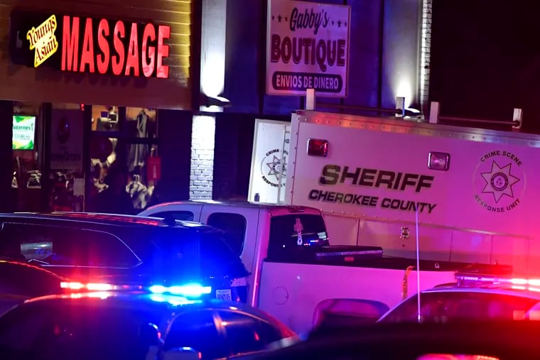 Authorities investigate a fatal shooting at a massage parlor in Woodstock, Ga.