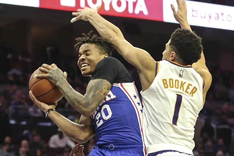 Markelle Fultz goes up against the Suns' Devin Booker during Monday's win.