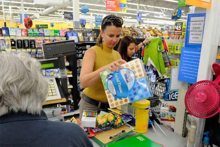 Customers at a Wal-Mart store in Alcoa, Tenn. While e-commerce has been rising for the company, brick-and-mortar sales have fallen for five quarters. MICHAEL PATRICK / Knoxville (Tenn.) News-Sentinel