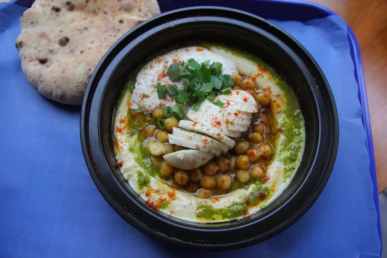 The hummus known as Go Hard or Go Home has extra chickpeas, ful (the pureed fava bean dish), egg, tahini, lemon, and olive oil. At Hummusology, 1112 Locust St.