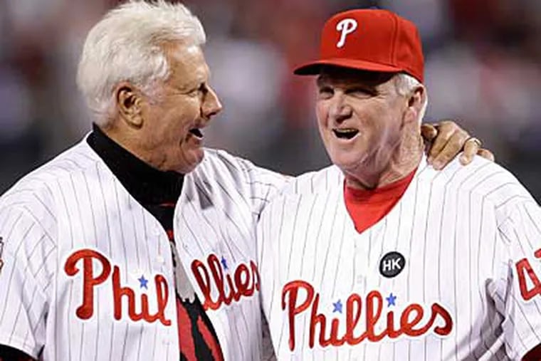 Former Phillies manager Dallas Green, left, hugs Charlie Manuel after Green threw out the first pitch before Game 5 of the NLCS. (AP Photo / Matt Slocum)