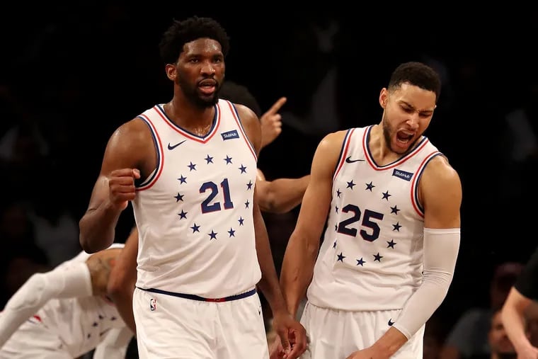 The Sixers' two young stars, Joel Embiid (left) and Ben Simmons, carried them to the finish line on Saturday.