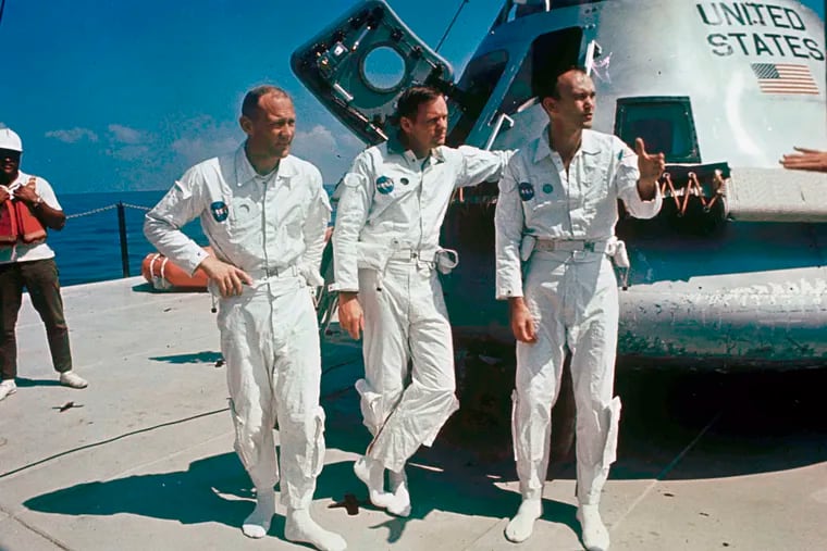 In this 1969 photo, Apollo 11 astronauts from left, Col. Edwin "Buzz" Aldrin, lunar module pilot; Neil Armstrong, flight commander; and Lt. Michael Collins, command module pilot, stood next to their spacecraft.