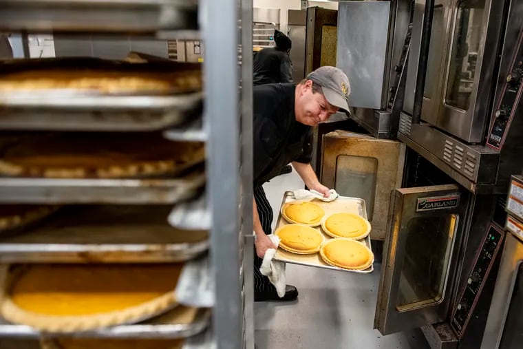 Eric Gantz, a staff working at MANNA, takes out pies from the oven last month. MANNA will deliver dinners fit for their clients living with serious illnesses in the Greater Philadelphia area.