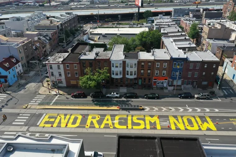 "End Racism Now" was the message demonstrators in Fishtown had for the city on Tuesday, painting the words in bold yellow letters on Girard Avenue, just outside Philadelphia police’s 26th District headquarters. The painting is seen on Wednesday, June 10, 2020.